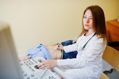 beautiful-young-doctor-doing-diagnostic-sonography-patient(1)